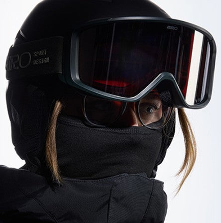 person wearing glasses with their ski goggles and ski helmet on