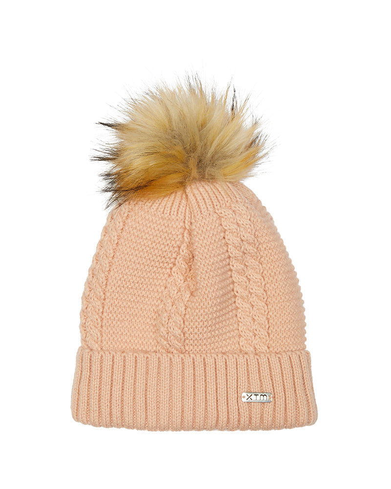 Beige knit beanie with a fur pom-pom on a white background rose cloud