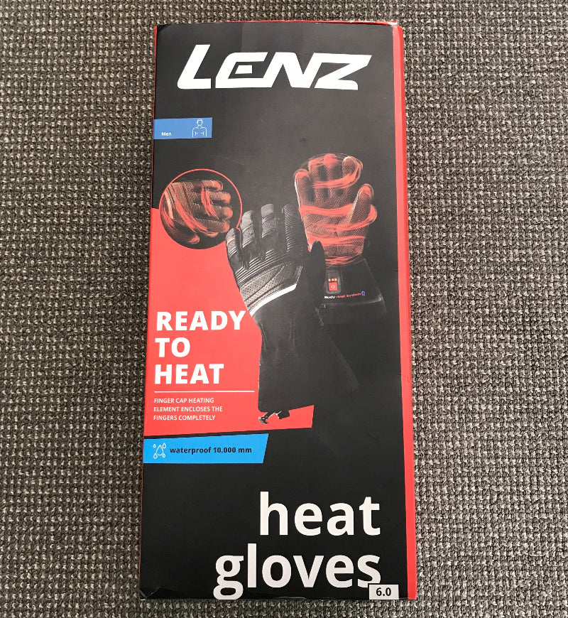 Lenz brand heat glove packaging box, size 6.0, featuring a black and red design with an illustration of a heated glove on a textured gray carpet background.