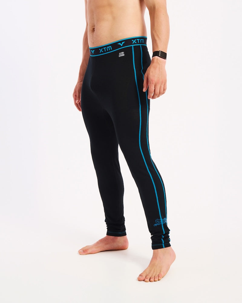 Person wearing black compression leggings with blue accents on a white background Valentino merino wool thermals base layer men's mens